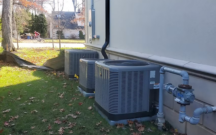 Pacific Air HVAC technicians installing a central air conditioning condenser