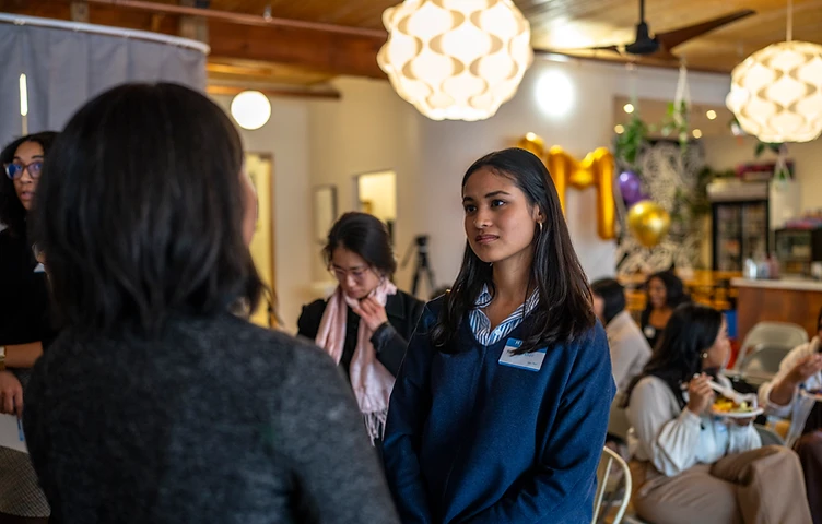 Two women in conversation at an Empower'em gathering
