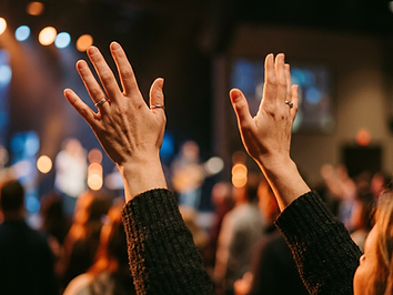 Hands raised in worship during a church service