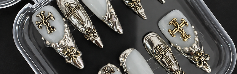 Stiletto press-on nail set with metallic silver Gothic charms in a clear case