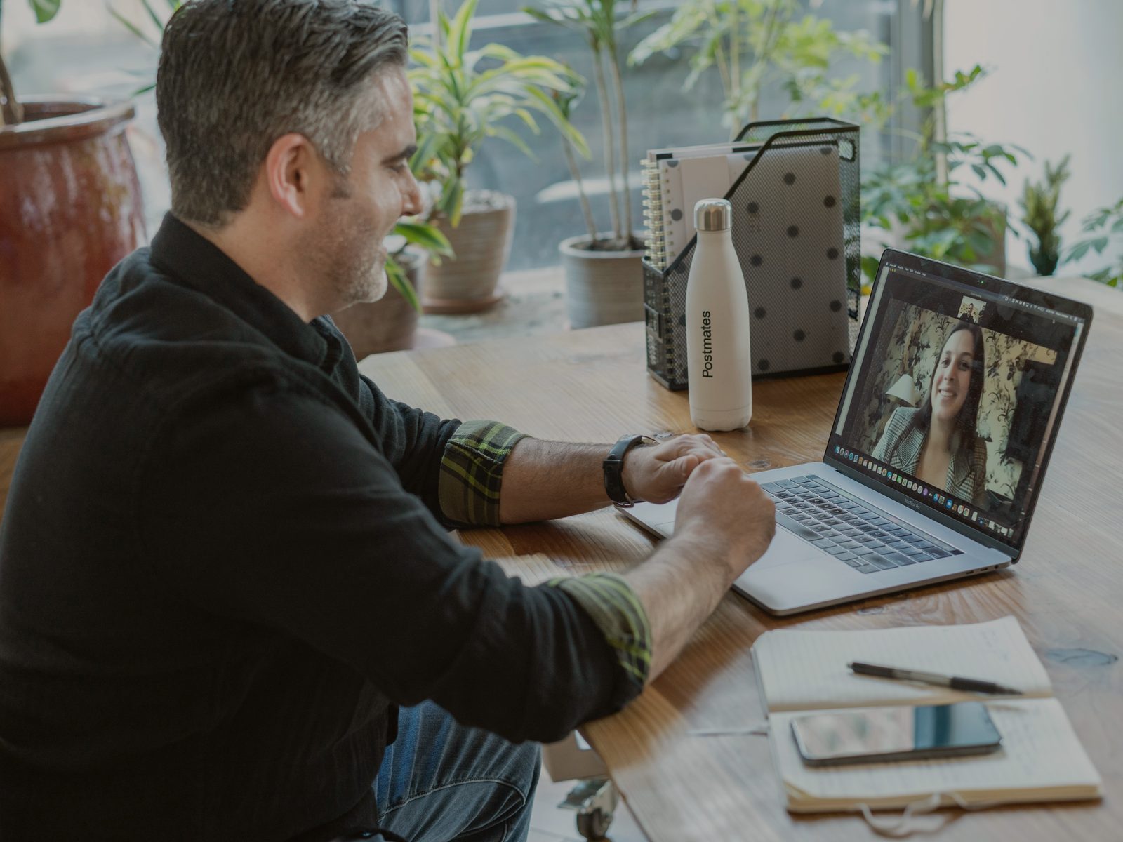 Professional talking to a customer on a laptop video call.