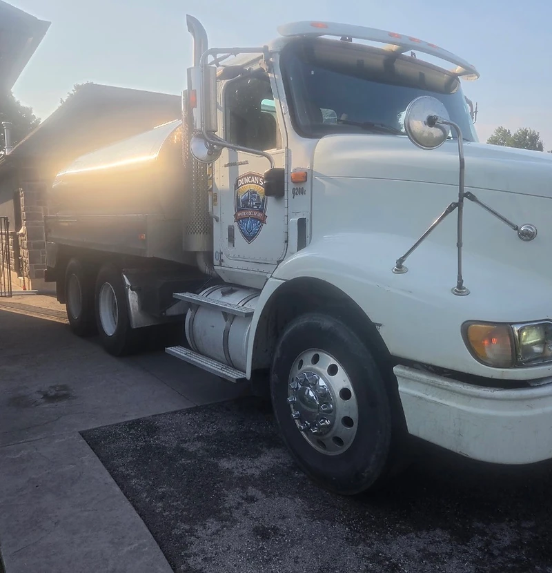 Duncan's Water Delivery potable water truck parked at a residence
