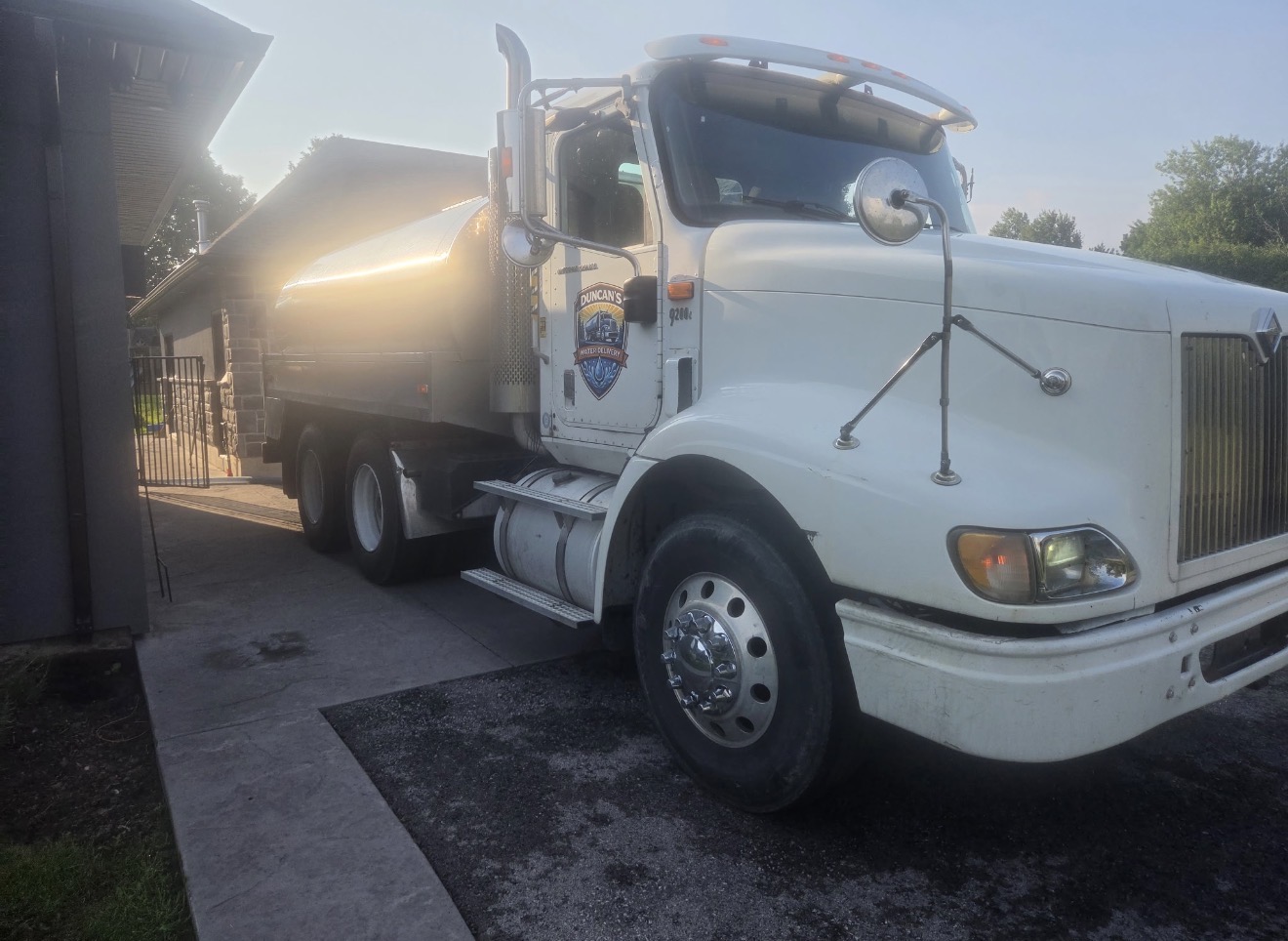 Branded Duncan's Water Delivery potable water truck parked at a residence