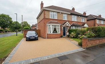 Finished resin driveway in front of a red-brick semi-detached house