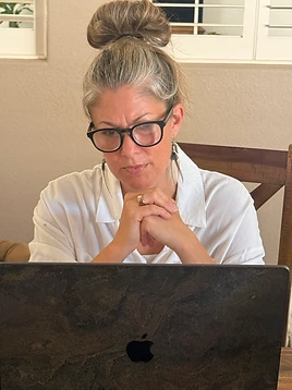 Kimberly Artley personally reviewing a submitted assessment at her laptop
