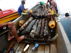 OJDC dive crew raising freshly recovered iron ingots onto the work boat in the waters of Ontong Java Atoll