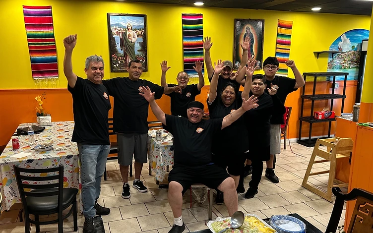 The El Alex Carnitas y Taqueria team posing inside the restaurant