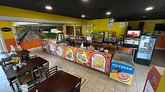 El Alex service counter with hand-painted menu mural