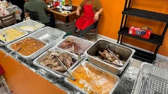 Catering buffet of carnitas, rice, and sides on the counter