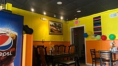 Dining area with town-square mural and serape decor