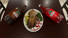 Carnitas plate with lime, cilantro, radish, and Jarritos Tamarind