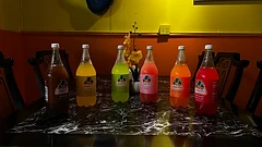 Six flavors of Jarritos lined up on the table