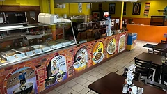 Counter mural arches of carnitas, menudo, and taquitos