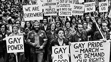 Historical Pride protest imagery with marchers holding signs advocating for 2SLGBTQIA+ rights