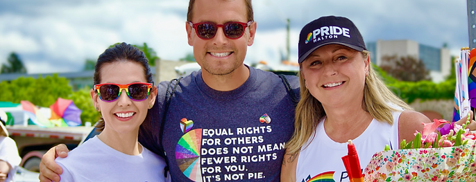 Pride Halton founder Melanie Tremills (centre, holding flowers) with Members of Parliament Kristina Tesser Derksen (left) and Adam van Koeverden (right) at a Pride Halton celebration