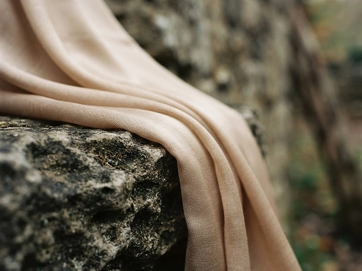 Chiffon fabric draped over weathered stone