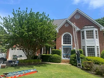 Home exterior with brick siding and white trim during painting, residential exterior painting in Odessa, TX