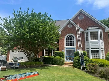 Home exterior with brick siding and white trim during painting, residential exterior painting in Odessa, TX