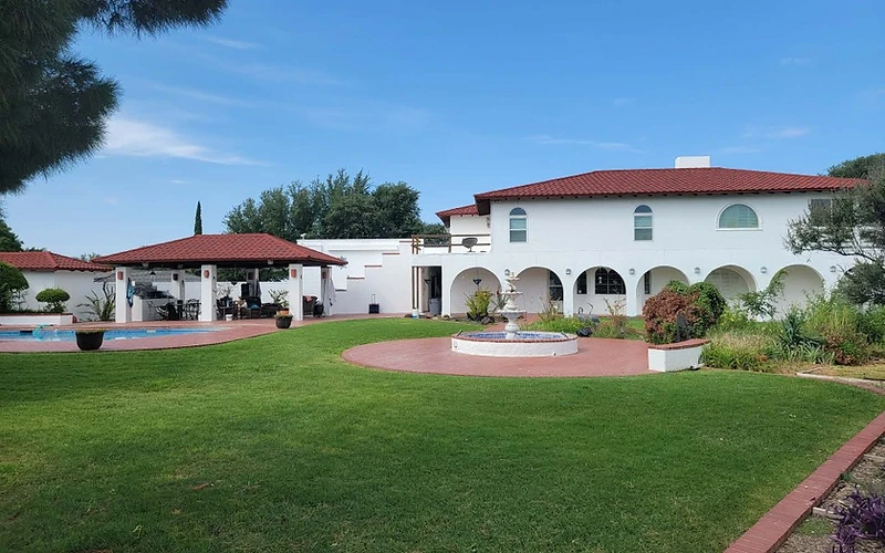 Spanish-style stucco home with freshly painted exterior and trim, residential exterior painting