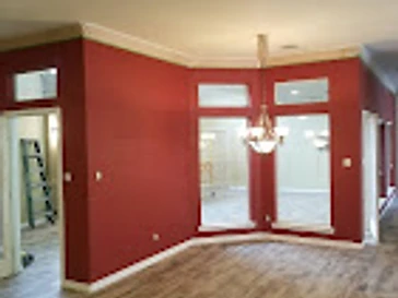 Corner with red accent wall and transom windows, residential interior painting in Odessa, TX