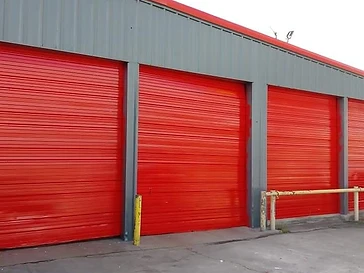 Commercial building with red bay doors and painted exterior, commercial exterior painting in Odessa, TX