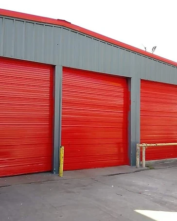 Commercial building with red bay doors and painted exterior, commercial exterior painting