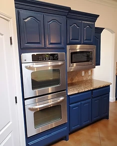 Navy blue kitchen cabinets with refinished finish, cabinet painting and refinishing