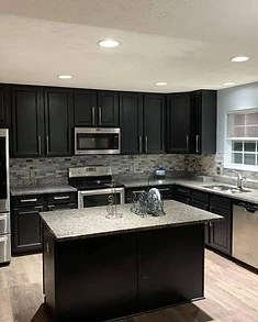 Black shaker cabinet doors with freshly refinished surface, cabinet painting and refinishing