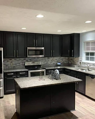 Black shaker cabinet doors with freshly refinished surface, cabinet painting and refinishing