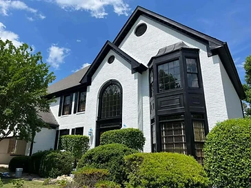White brick home exterior with black trim, residential exterior painting in Odessa, TX