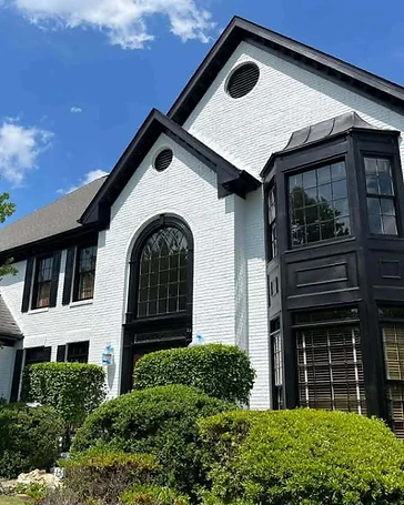 White brick home with black trim, residential exterior painting