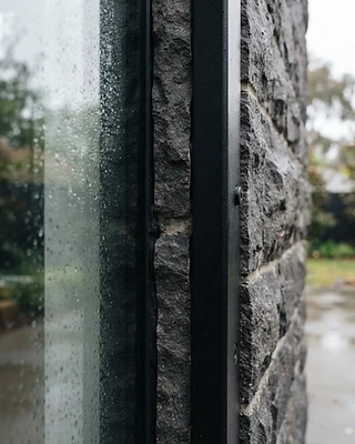 Basalt Retreat — basalt and glass detail