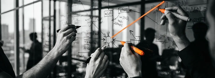 Hands mapping an organizational transformation strategy