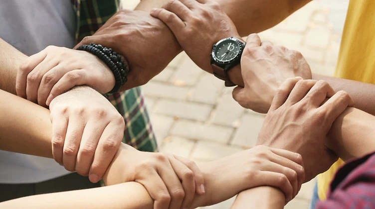 Hands joined together in a circle of support