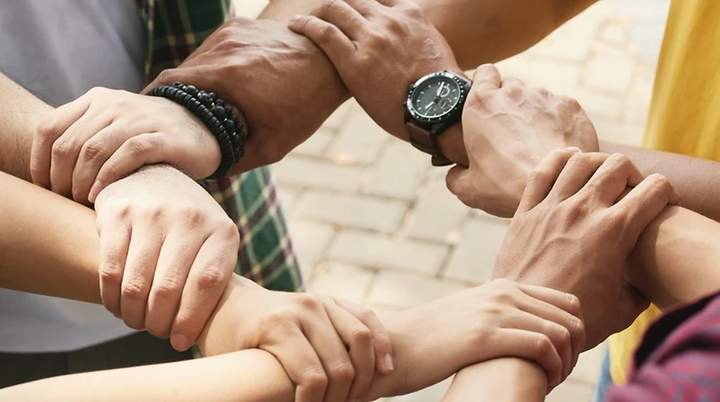 Hands joined together in a circle of support