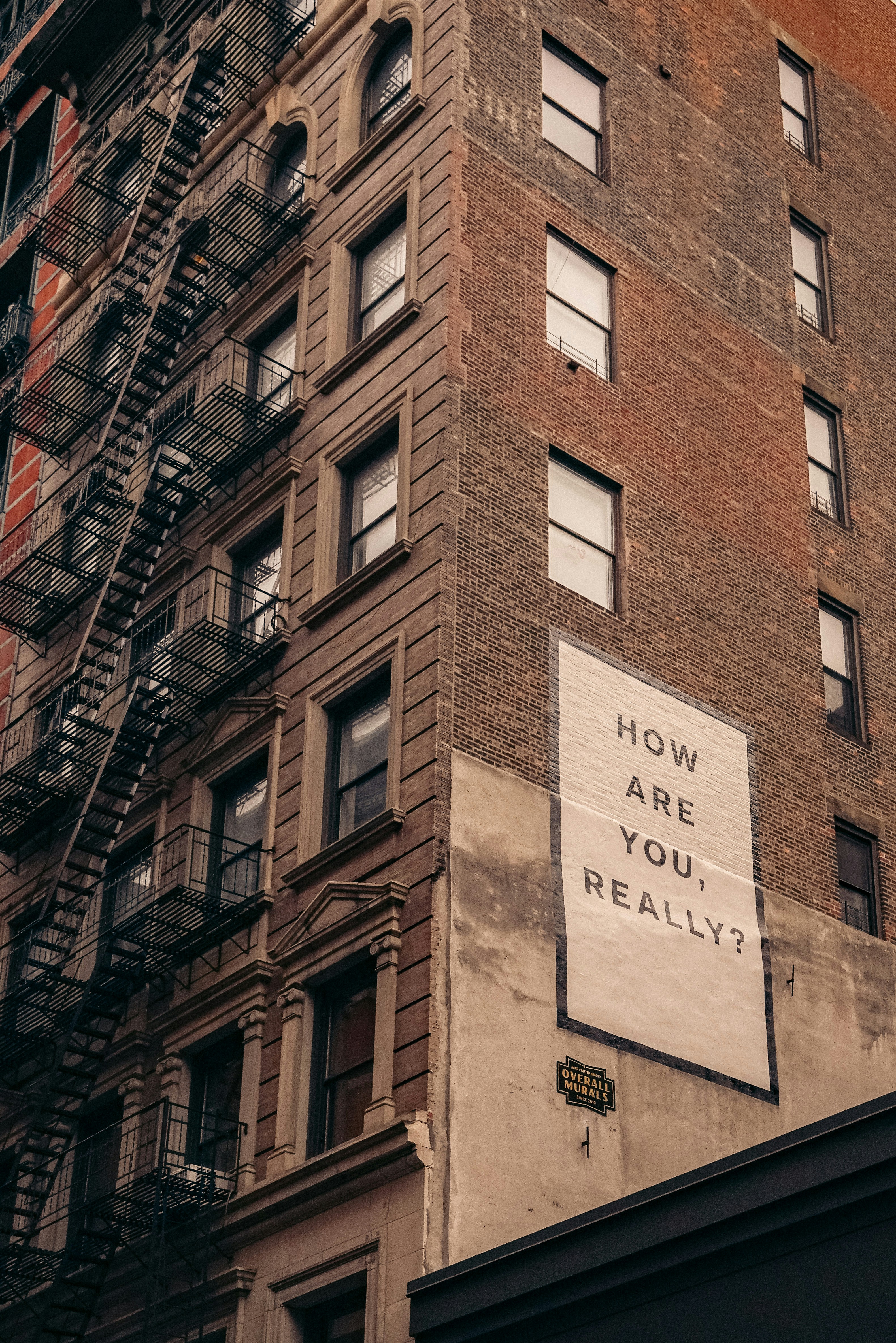 A building wall painted with the words How Are You Really