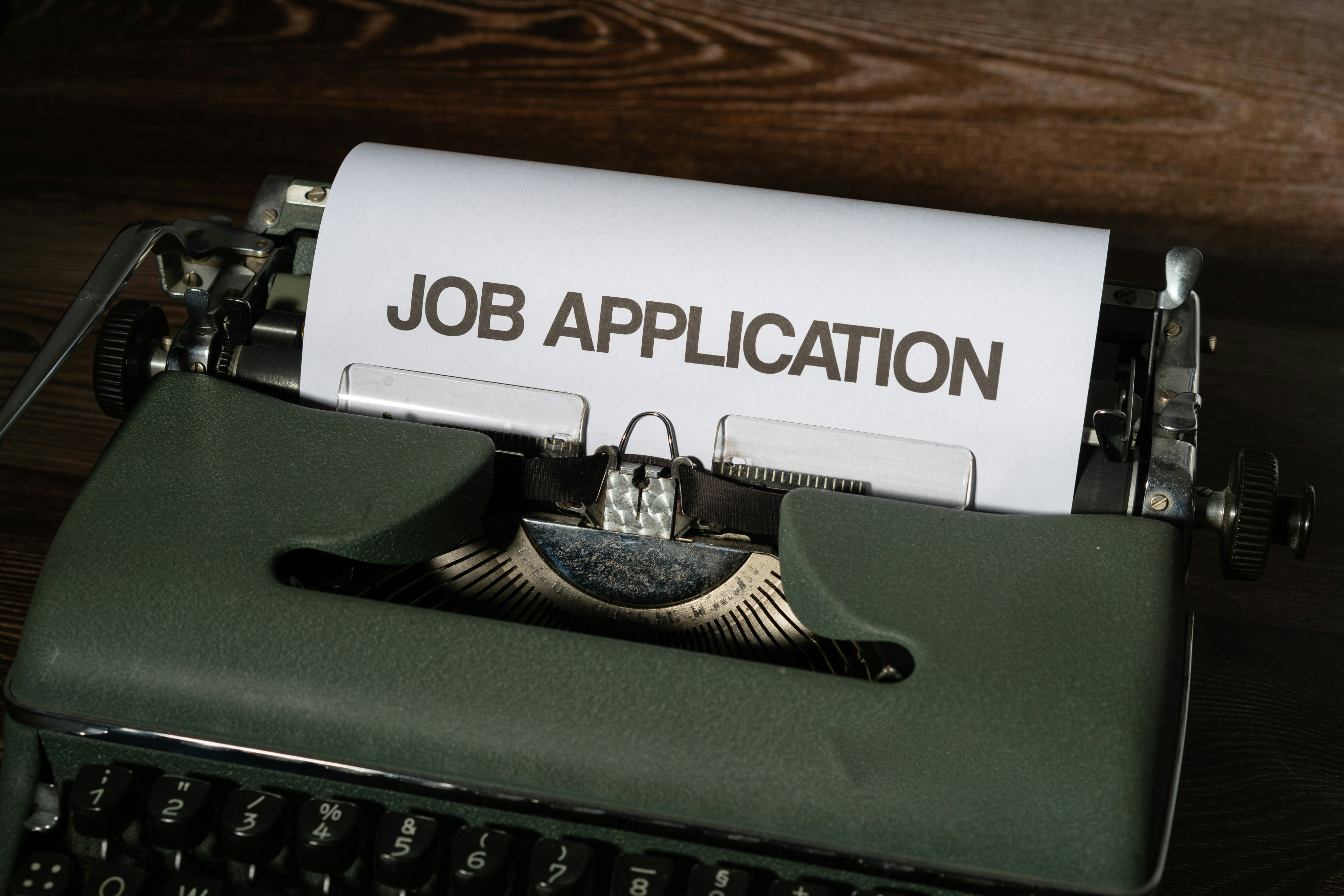 A typewriter with the words Job Application