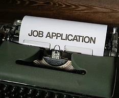 A typewriter with the words Job Application