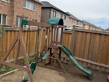 KidKraft swing set installed on grass / ground in Brampton, Ontario — photo 1