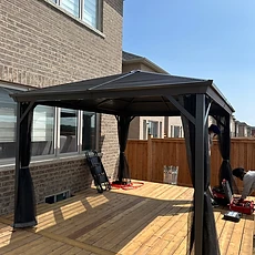 A finished outdoor pergola with clear overhead beams.