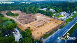 Commercial concrete parking lot installation with curbs, gutters, and drainage infrastructure