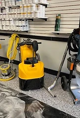 Industrial-grade floor polishing equipment and dust collection system at the Xtreme Polishing Systems showroom