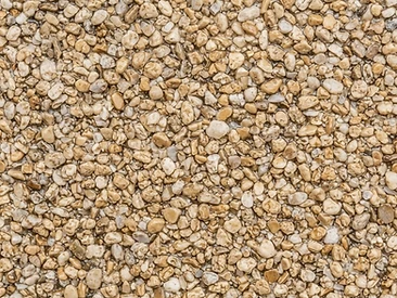 Warm Buff resin-bound aggregate close-up showing natural washed stone in clear resin