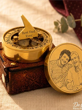 Antique brass sundial compass with photo engraving on linen