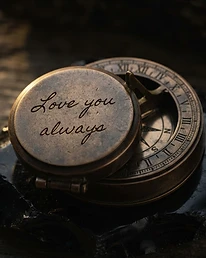 Handwriting engraving on an engraved brass compass lid