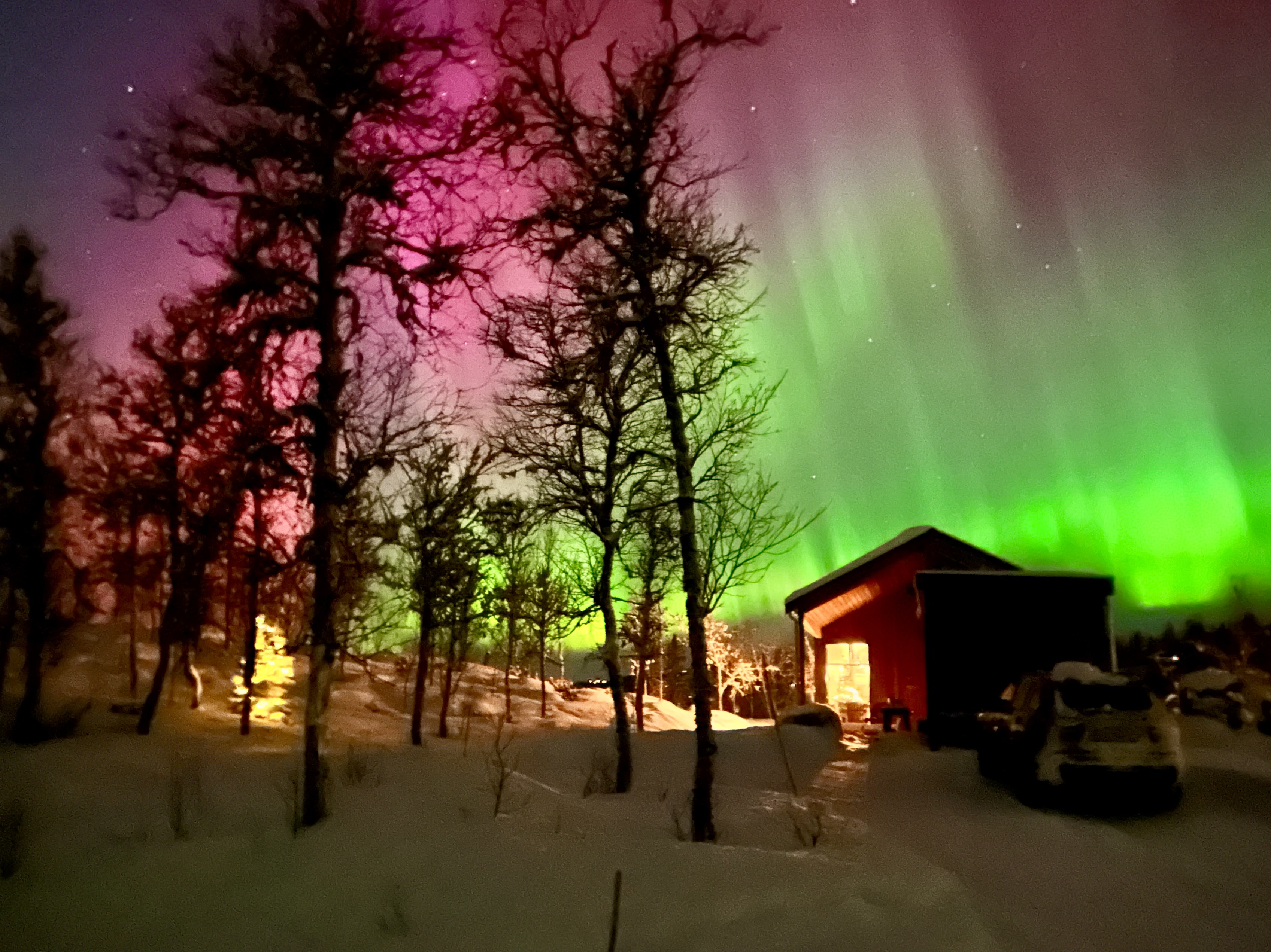 The Northern Lights above a modern cabin in Hol, Norway