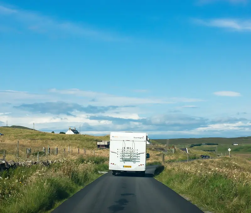 Motorhome travelling through the rolling hills of Scotland