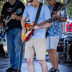 Guitarist playing a sunburst Les Paul on the gazebo stage