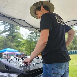 Sound engineer running the mixing board under the tent