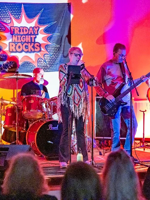 Over and Out performing live under magenta and yellow stage lighting